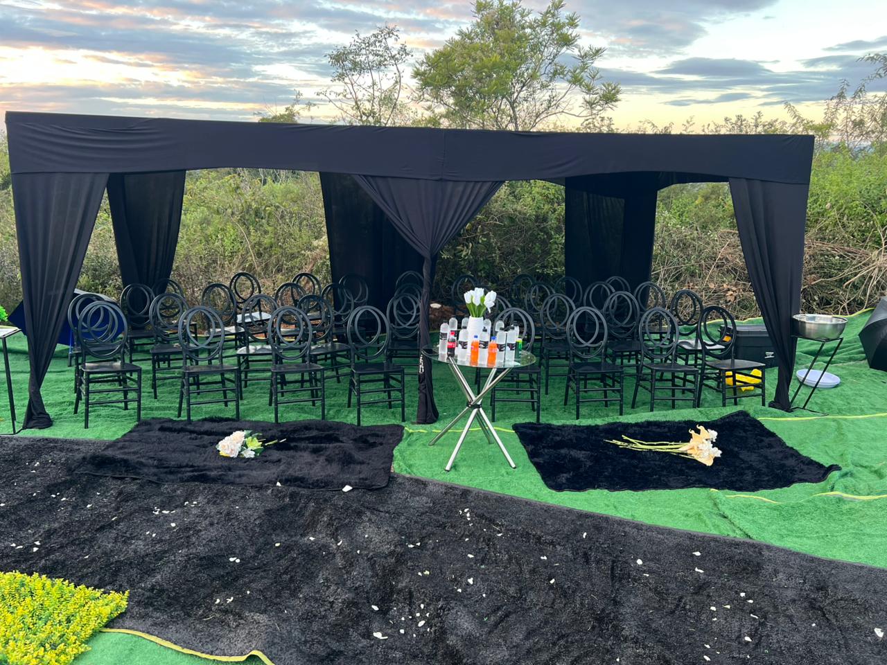 NEMAS graveside ceremony — black canopy and seating on green