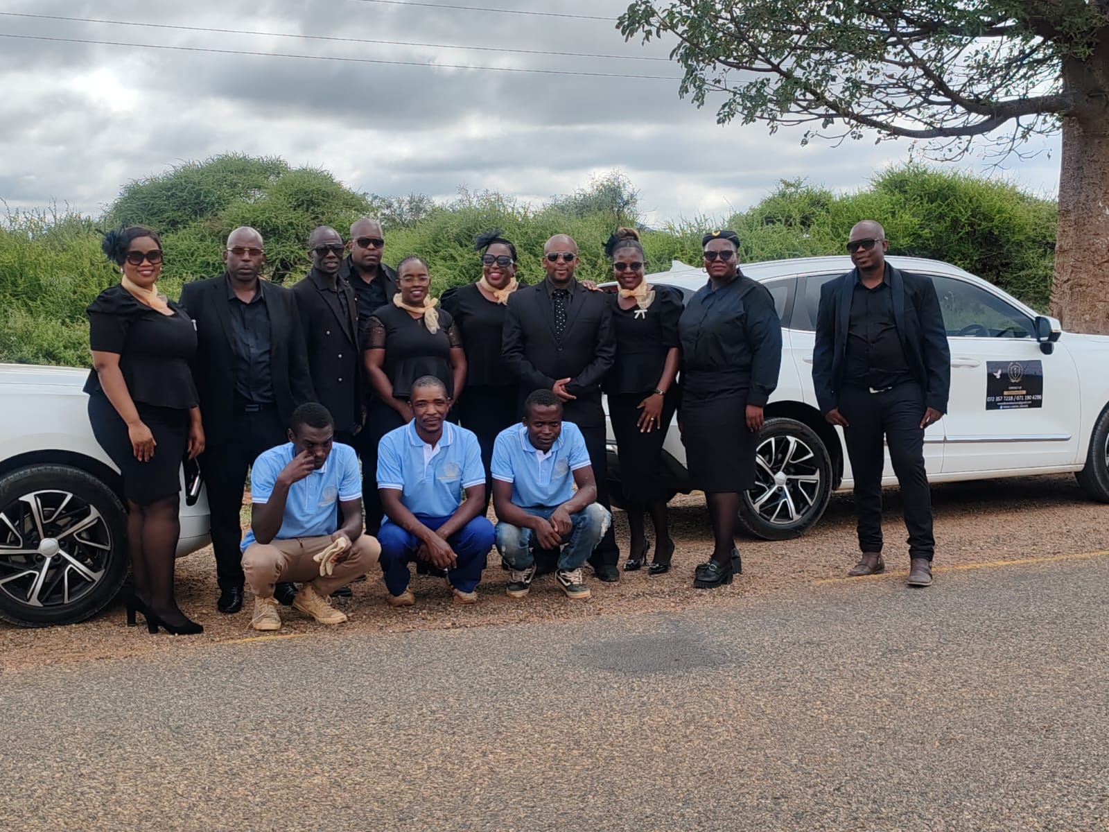 Full NEMAS team beside company fleet